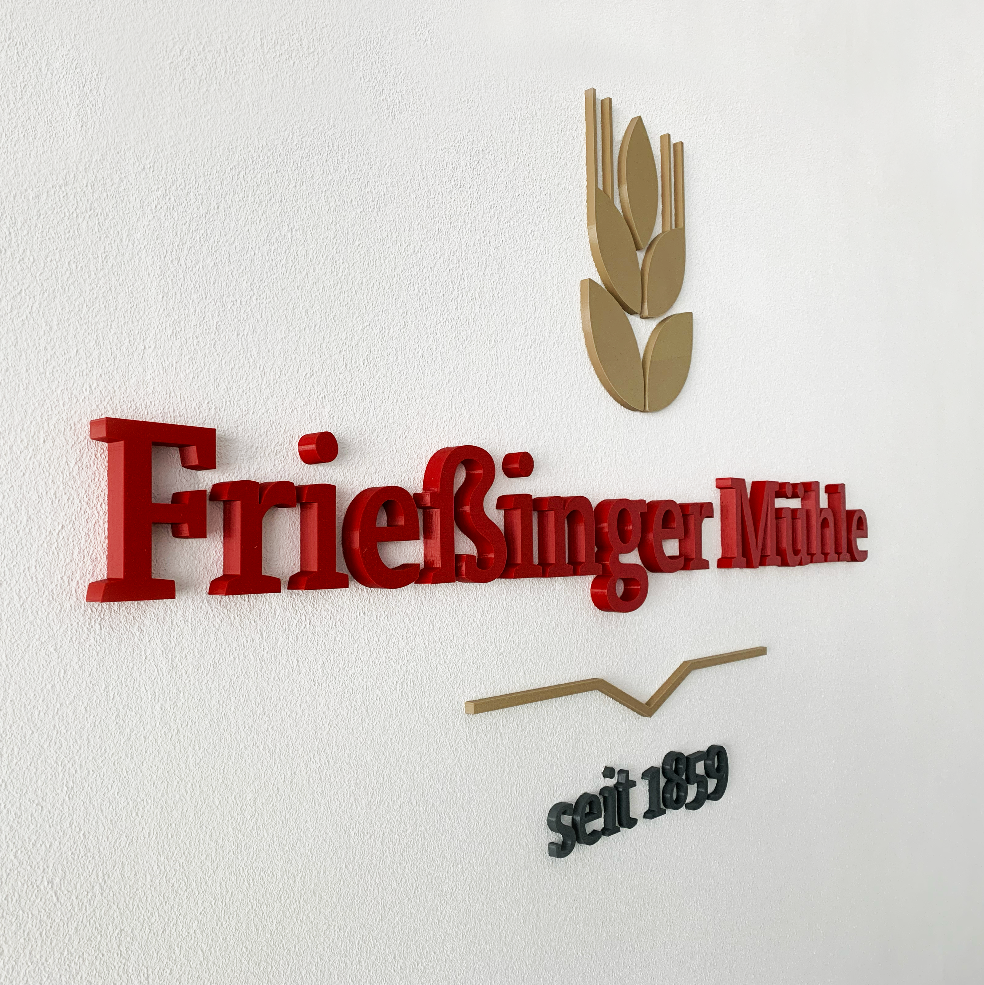 Erhabenes Frießinger Mühle Logo im Besprechungszimmer an der Wand 
